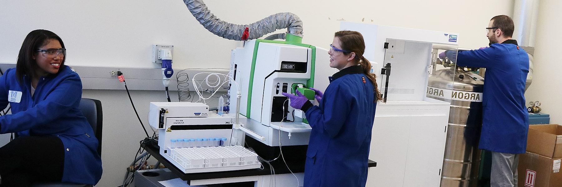 graduate students using lab equipment